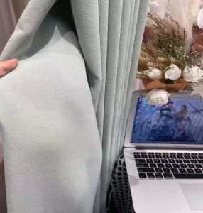 thick textured green blackout curtain fabric detail