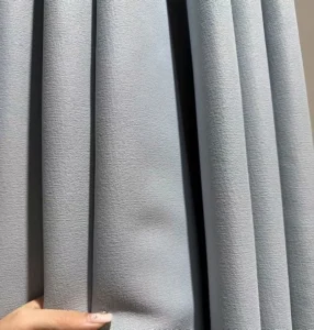 Solid grey faux linen blackout curtain material showing elegant drapery folds