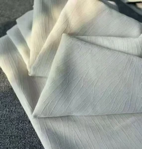 Folded embossed water ripple curtain fabric in bulk rolls, perfect for hotel projects