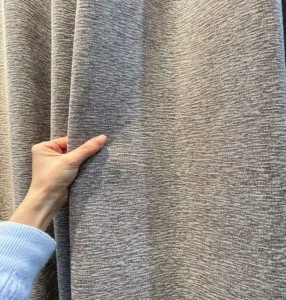 Double-sided acoustic curtain fabric showing heavy drape and thermal insulated