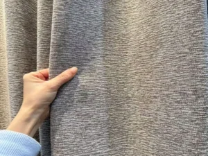 Double-sided acoustic curtain fabric showing heavy drape and thermal insulated