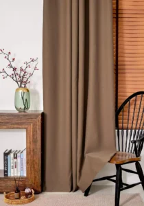 Premium 900gsm heavy duty brown curtain fabric hanging in a modern living room, featuring 85% blackout performance and thermal insulation for cold climates.