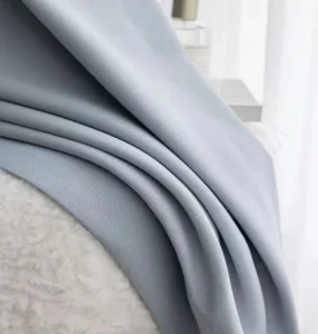 Elegant drape effect of solid textured blackout curtain in light grey blue