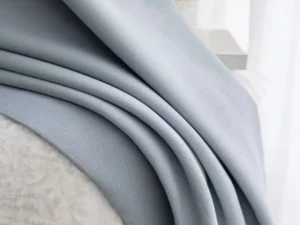 Elegant drape effect of solid textured blackout curtain in light grey blue