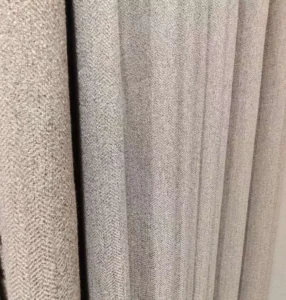 Close-up texture of 1300g heavyweight faux linen blackout curtain fabric with high shading performance.