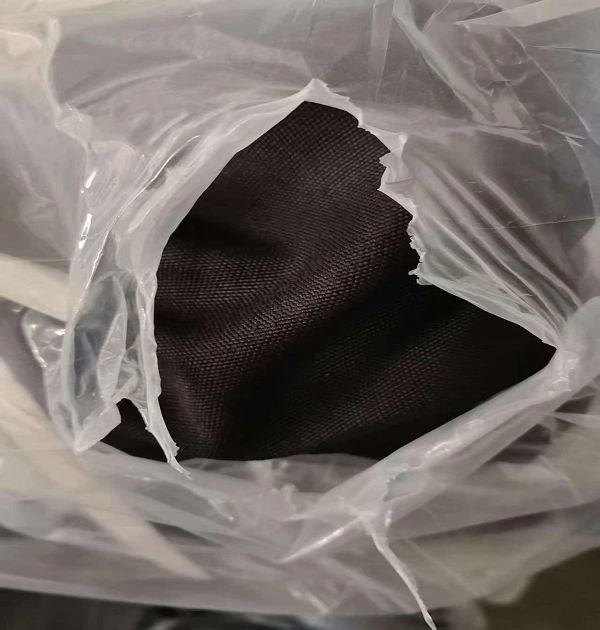 Close Up Texture Of Dark Bulk Faux Linen Blackout Curtain Fabric In Warehouse Packaging`