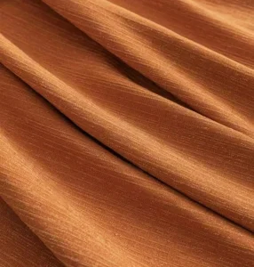 Ultra-soft minky fleece curtain fabric in rich orange, providing luxurious drape and 95% room darkening for 5-star hotels.