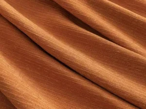 Ultra-soft minky fleece curtain fabric in rich orange, providing luxurious drape and 95% room darkening for 5-star hotels.